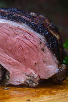 a piece of meat sitting on top of a wooden cutting board