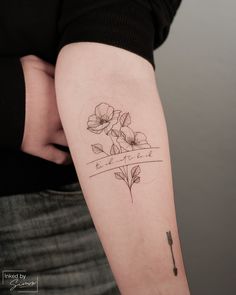 a woman with a flower tattoo on her arm