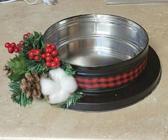 a dog bowl is decorated with holly and cotton balls