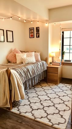 a bed sitting in a bedroom next to a window