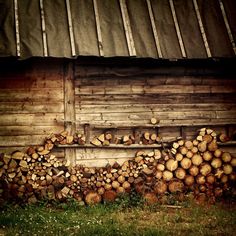 a pile of wood sitting next to a building