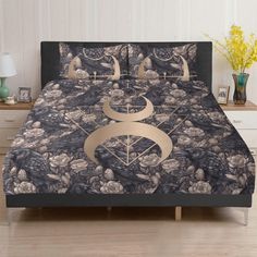 a bed covered in a black and gold comforter