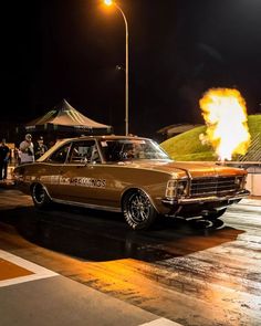 an old car with flames coming out of it