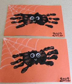 two handprinted pictures of spider on orange paper with numbers 2012 and 2012 written in black