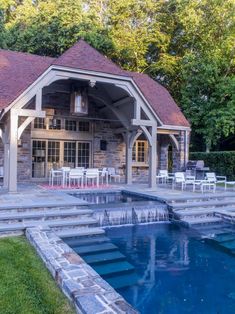 a house with a pool in the middle and some chairs on the other side by it