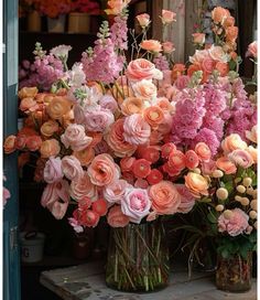 a vase filled with lots of pink and orange flowers