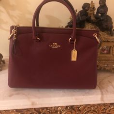 Beautiful Brand New Coach Satchel With Long Adjustable Strap For Shoulder Wear. Red Burgundy Color With Gold Hardware. It Has 3 Compartments. Measurements Approximately 13 1/2 By 9 Inches Burgundy Coach Bag, Elegant Coach Satchel With Zipper Closure, Red Coach Shoulder Bag For Office, Elegant Red Satchel With Zipper Closure, Luxury Burgundy Coach Bag, Coach Burgundy Bag With Top Carry Handle, Burgundy Bags With Gold-tone Hardware And Double Handle, Burgundy Office Bag With Gold-tone Hardware, Burgundy Double Handle Bags With Gold-tone Hardware