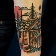 a small house tattoo on the arm