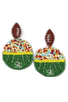 "Our new beaded football stadium earrings are so adorable! I know I am ready for Fall and Football and these adorable earrings show your love for the sport. These cuties are  perfect for any team's game.  Beaded with green, yellow and brown seed beads, multi color bugle beads and silver accents. These statement earrings are a football post style dangle earring with push back closure. The design is the 50 yard line and the sports fans in the bleachers dangling from a football.  The earrings are made on felt so they are not a hard or heavy earring. They are so pretty and eye catching.  How adorable would these be at any football event, from kids, high school, college and professional. Also, home parties,  beach, poolside, parties and more. Perfect with your favorite team colors. Our adorable Fall And Football, Ballet Earrings, Sports Earrings, The Bleachers, Mom Earrings, Football Earrings, Western Earrings, Silver Caps, Fan Earrings