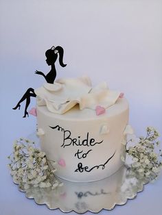 a wedding cake with bride and groom silhouettes on it