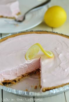 a pie with a slice taken out of it on a table next to a lemon