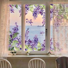 two chairs sitting in front of a window with purple flowers on it