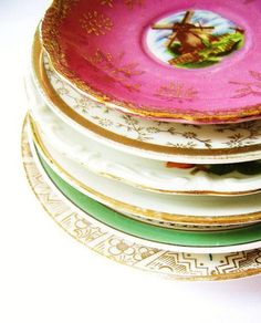 a stack of colorful plates sitting next to each other on top of a white table