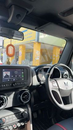 the interior of a car with dashboard, steering wheel and electronic display on the dash