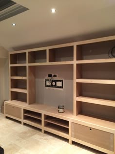 a living room filled with lots of wooden shelves