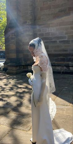 a woman wearing a wedding dress and veil