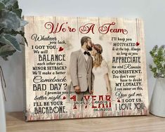 a wooden sign with the words we're a team and an image of a couple kissing