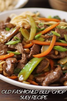 a white bowl filled with stir fry beef and veggies on top of noodles