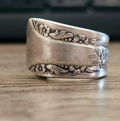 a silver ring sitting on top of a wooden table