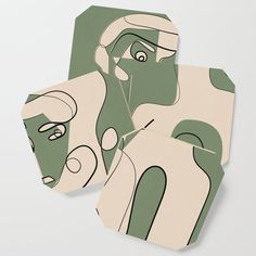 two coasters with green and white designs on the top one has an image of a woman's face