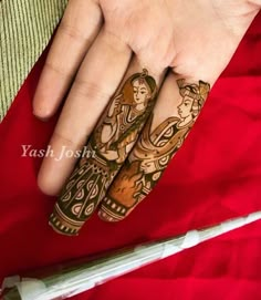 two hands with hendi designs on them