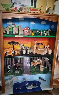 an open book shelf filled with wooden animals