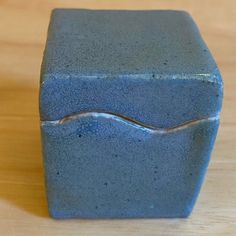 a blue square object sitting on top of a wooden table