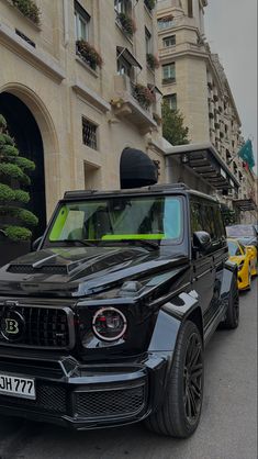 a black suv parked in front of a building