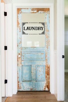 an old blue door with the word laundry painted on it