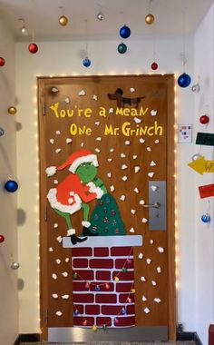 a door decorated to look like the grinch is coming out of his chimney for christmas