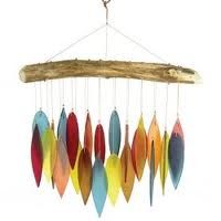 a wind chime with colorful feathers hanging from it's hooks on a branch