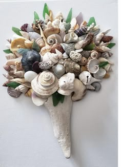 a bunch of seashells are arranged in a vase