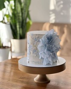 a white cake with blue flowers on top