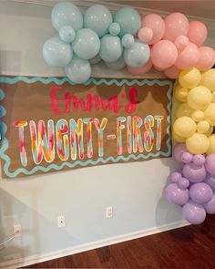 there is a sign that says twenty first and balloons in the air on the wall