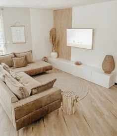 a living room filled with furniture and a flat screen tv mounted to the side of a wall