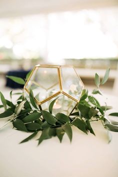 the table is covered with greenery and candles