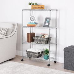 a living room with a white couch and a book shelf in the corner next to a chair