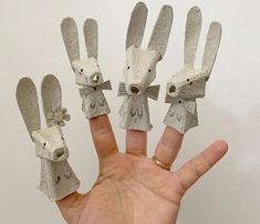 a hand that has some kind of fake animal on it's fingers and four small ones in the middle