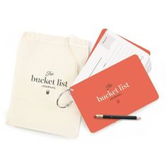 the bucket list is sitting next to a bag with a pencil in it and some other items