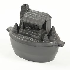 a black bowl with a house in it