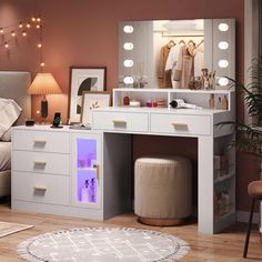 a white vanity table with lights on it and a stool in front of the mirror