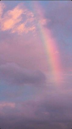 a rainbow is seen in the sky above some buildings