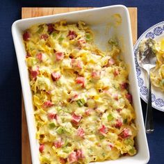 a casserole dish with ham and cheese in it on a blue table cloth