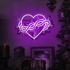 a purple heart shaped neon sign on the wall next to a christmas tree and framed pictures