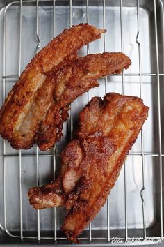 three pieces of meat sitting on top of a grill