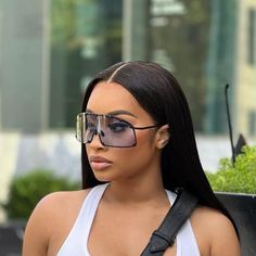 a woman with sunglasses and a white tank top