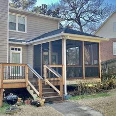 a house with a screened porch and stairs