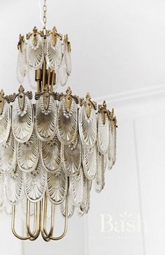 a chandelier hanging from the ceiling in a room with white walls and flooring