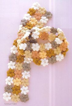 a crocheted scarf with flowers on it