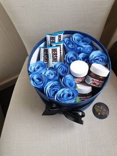 a blue bowl filled with lots of different types of stuff on top of a chair